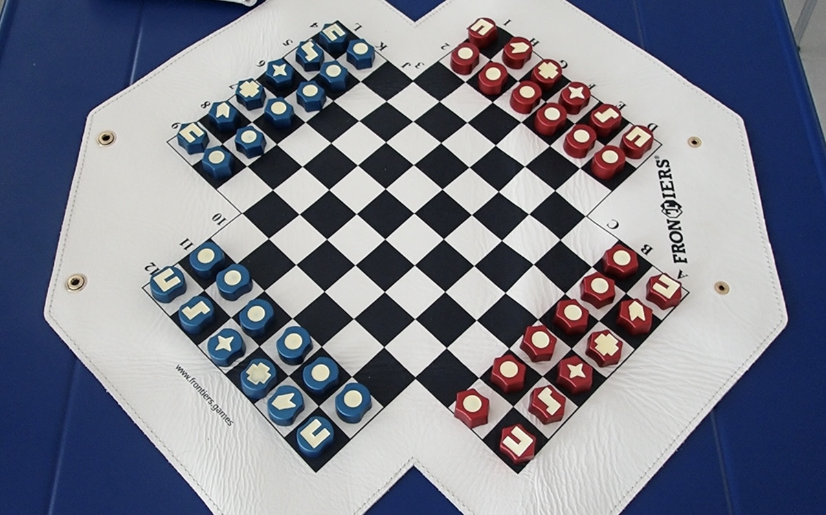 Physical FRONTIERS game on a cream four-wing board with red and blue playing pieces.